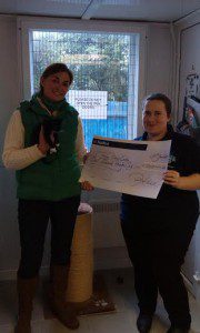 Blue Cross Volunteer  Pam Lee hands  Lorna Sheppard (Fundraising chair,)The cheque for £1000