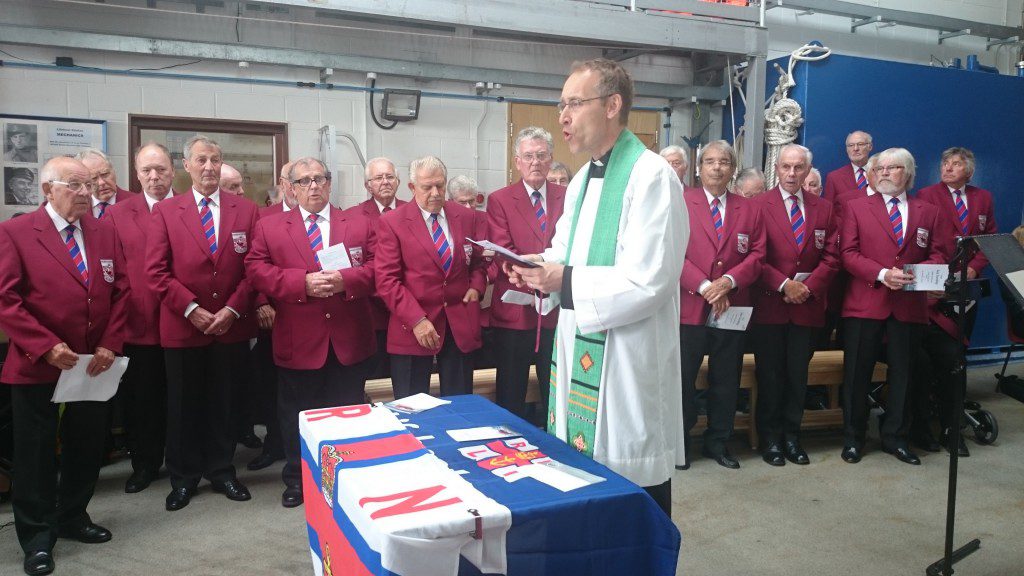 Station Chaplain, Rev. James Hutchings addresses the congregation with the Budleigh Salterton Male Voice Choir in the background. 