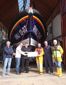 Casualties hand over a cheque to station volunteers who played a part in their rescue. L to R: Deputy Launching Authority, Neil Matson; Casualties, Richard Smith and Jared Colclough; Coxswain, Steve Hockings-Thompson; Mechanic, Mark Sansom and Tractor Driver, Neil Cannon. (credit: Exmouth RNLI) 