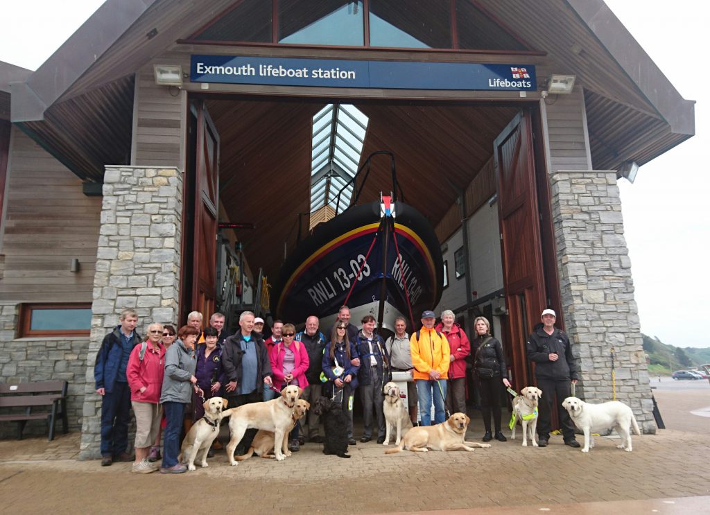 Derek and Neil with their visually impaired visitors, helpers and dogs in front of Exmouth lifeboat station. Photo: Exmouth RNLI