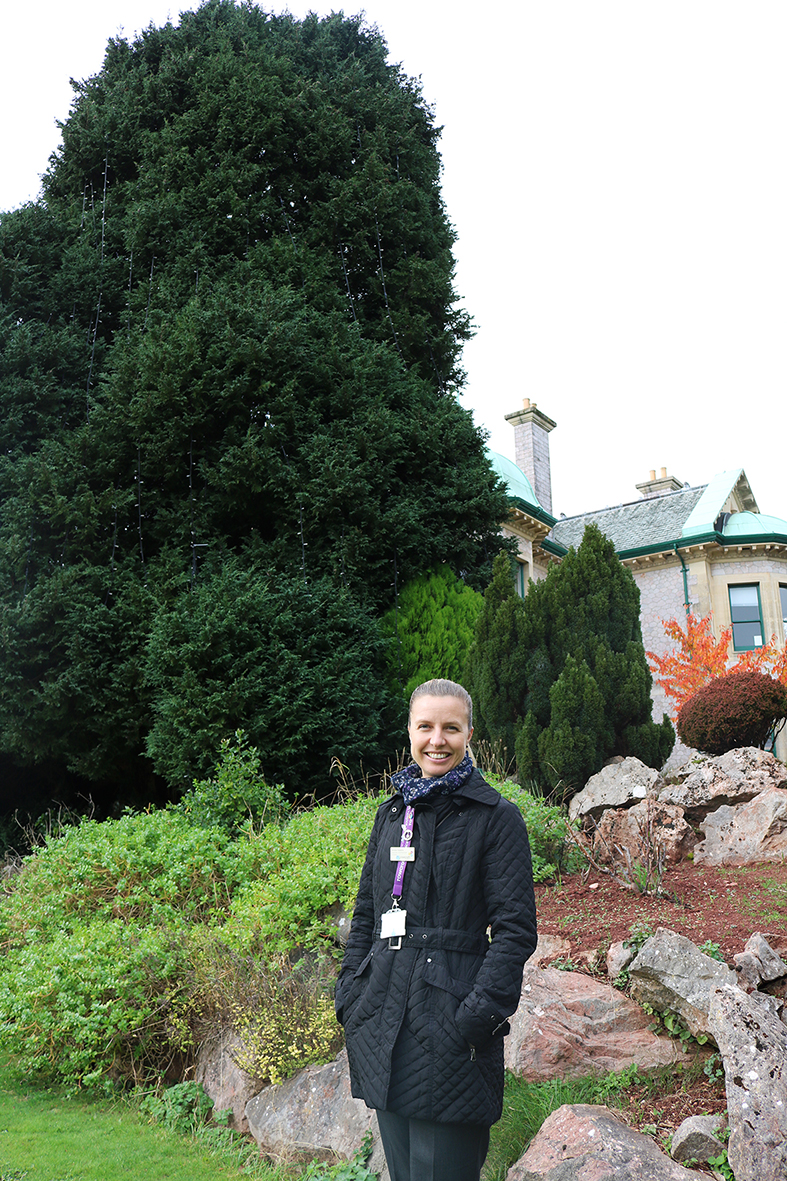 Rowcroft’s Family and Friends Fundraising Manager, Daniela Hopkins, standing in front of Rowcroft’s Tree of Light